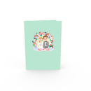 Carte pop-up Jeunes mariés sous une arche florale